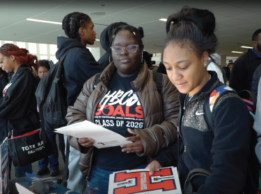 girl looking at howard university sign